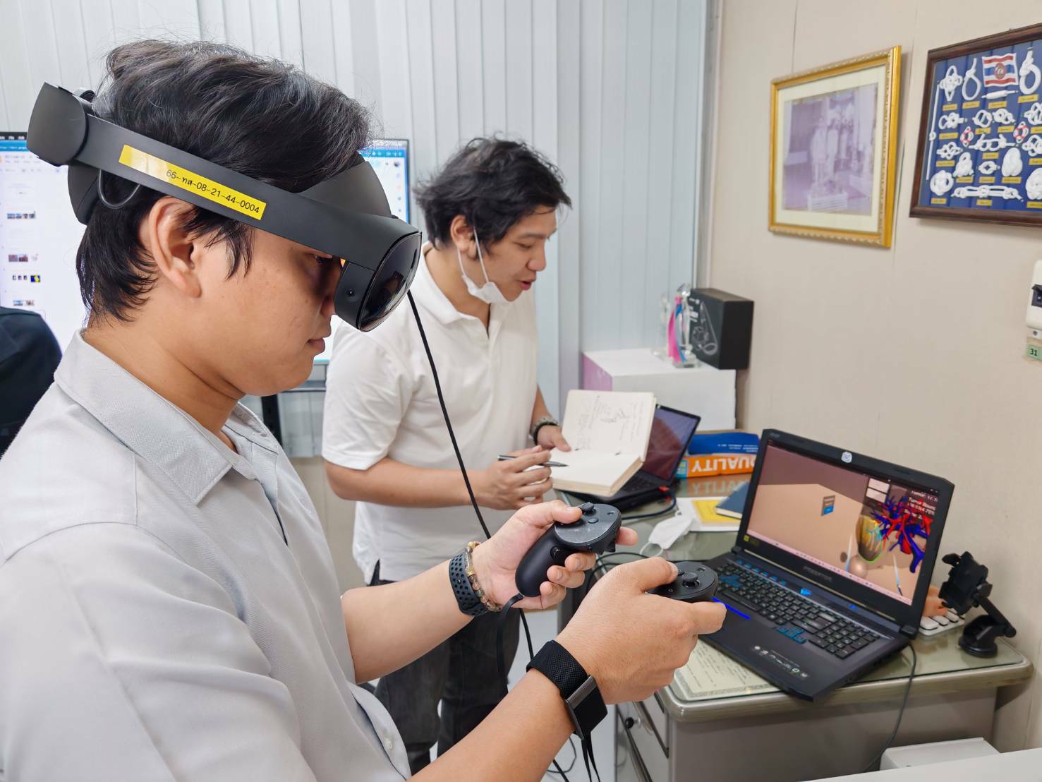 Team members testing the ReaLiver VR system with headset and controllers